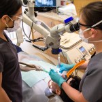 Dental team assisting with patient treatment