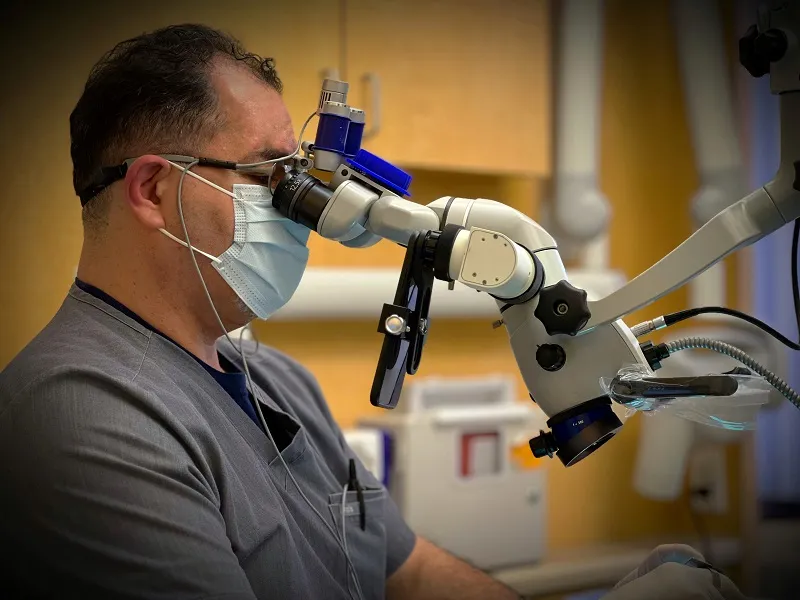 Doctor using microscope 