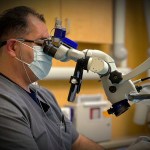 Doctor using microscope 