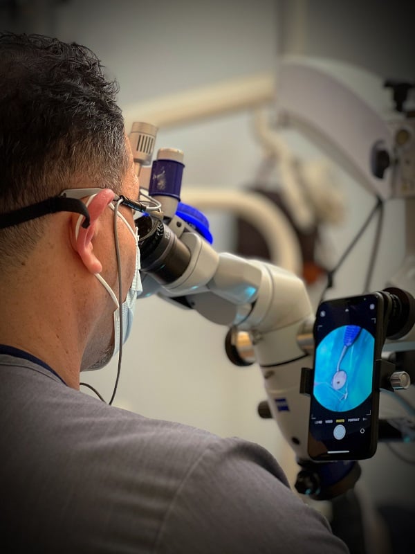 Doctor using microscope side view