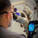Doctor using microscope side view