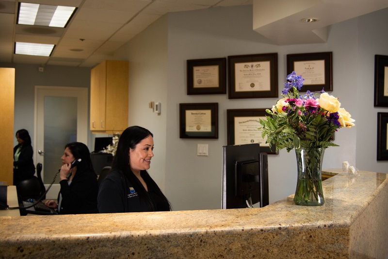 Inside front desk of office with staff