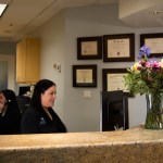 Inside front desk of office with staff